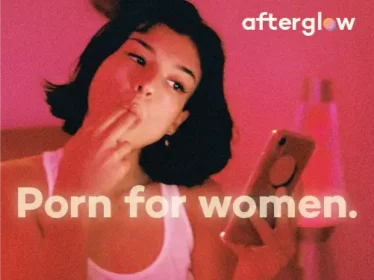Afterglow pink banner, with a woman sucking her fingers whilst looking at her phone. Porn for women. 