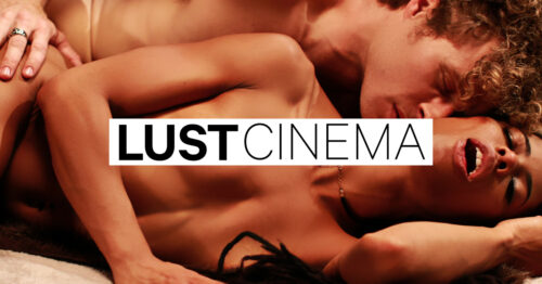 A woman moans orgasmically as her partner nuzzles her neck, with the words "LUST CINEMA" overlaying their naked bodies.