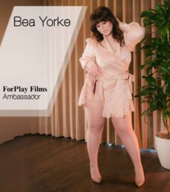 Redhead BBW Bea Yorke, ForPlay Films feminist porn ambassador, poses in a pink robe that barely covered her lush curves