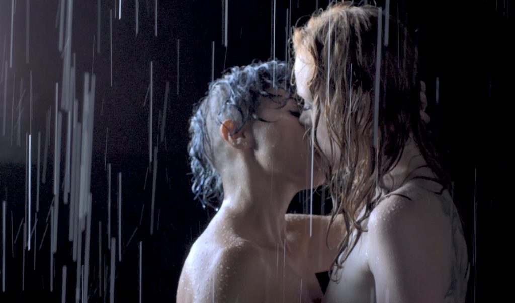 Phoenix Rae and Lila Alma kiss under pouring rain, in "Il Pleut", a feminist, queer, lesbian erotic film for women, by ethical porn studio ForPlay Films.